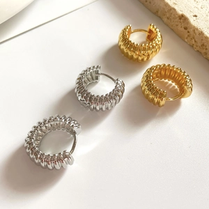Minimalist textured hoop earrings set in gold and silver finish with ribbed pattern