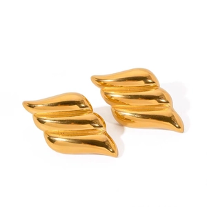 Detail view of 18K gold plated triple-layered wing earrings with a polished wavy texture