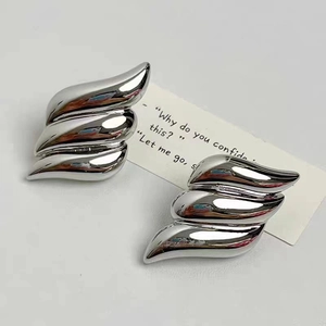 Three-layer 18K gold plated wing-shaped earrings with a polished silver metallic finish