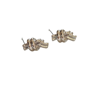 Minimalist knot-shaped sterling silver stud earrings with high-polish metallic finish