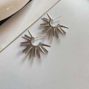 Close-up of S925 sterling silver sunflower earrings with polished spiky radial sunburst design