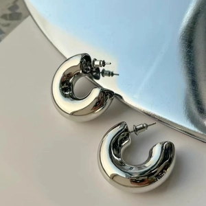 Polished silver C-shaped hoop earrings in 18K gold plated copper for women