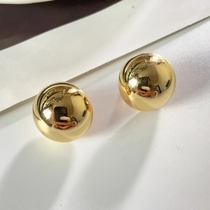 Boucles d'oreilles boules dorées minimalistes avec une finition métallique polie