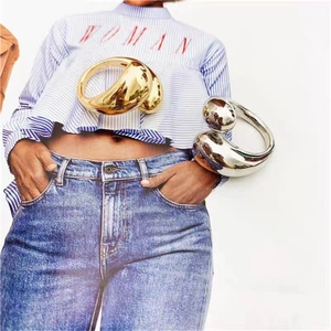 Polished gold and silver teardrop open rings with a minimalist sculptural design for women
