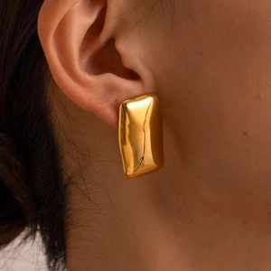 Macro view of gold irregular rectangular earrings with organic molten metal texture