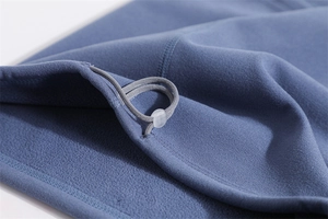 Detail of adjustable drawstring toggle on blue fleece neck gaiter with fine stitching