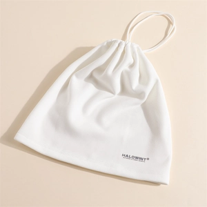 Detail of white fleece drawstring storage bag with premium embroidered brand logo