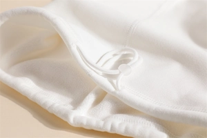 Close-up of soft white fleece neck warmer with adjustable drawstring and toggle buckle