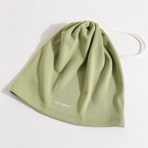 Detailed view of sage green fleece neck warmer with adjustable drawstring and logo