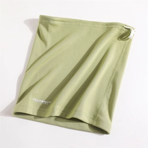 Detail view of adjustable drawstring and knitted texture on light green neck gaiter