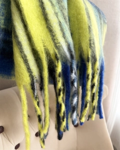 Close-up of rainbow mohair knit scarf with long tassels showing soft plaid texture