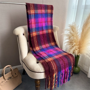 Detail of colorful plaid mohair scarf with thick texture and long decorative fringes