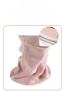 Detail of pink and white striped neck gaiter showing soft white plush lining texture