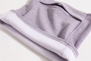 Detail view of purple knitted neck gaiter with soft fleece lining for winter warmth