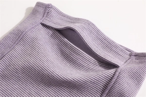 Macro detail of purple striped thermal neck gaiter showing hidden pocket and ribbed texture