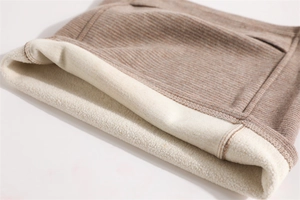 Close-up of winter neck gaiter featuring brown striped fabric and thick fleece lining