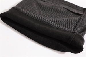 Detail of grey ribbed knit fabric with warm black fleece lining and durable stitching