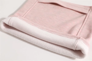 Detail of pink striped knit gaiter showing soft white fleece lining for winter warmth