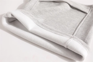 Close-up of thick thermal gray ribbed knit fabric with soft white fleece lining detail