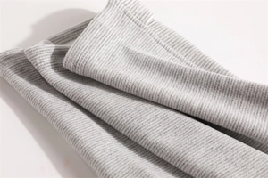 Close-up of light gray ribbed fleece fabric showing soft texture and elastic knitting