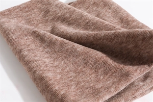 Close-up of brown knitted winter neck warmer showing soft ribbed texture and fabric detail