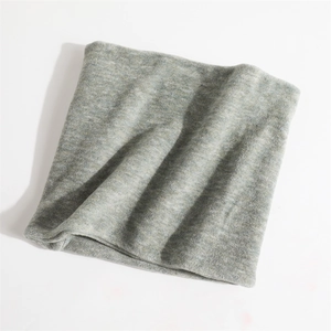 Detail of grey knitted neck warmer showing fine texture and soft fabric material