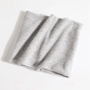 Detail view of the soft light grey thermal fleece lining and knit texture of the neck warmer