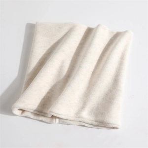 Detail shot of a thick cream fleece neck gaiter with soft insulated thermal texture