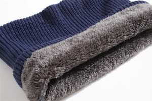 Detail of blue ribbed knit exterior and soft gray fleece lining for winter neck warmer
