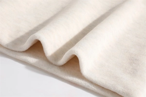Detail shot of soft white plush fleece fabric with thick warm texture for winter scarf