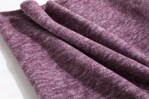 Close-up of thick plum purple knitted fabric showing soft thermal texture and fleece detail