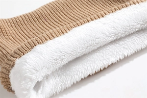 Detail of winter neck warmer showing brown ribbed knit and thick white fleece lining