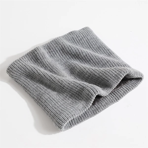 Close-up of gray knitted neck warmer showing thick ribbed texture and warm fabric
