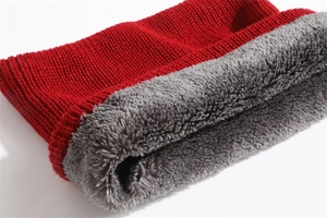 Detailed close-up of thick red knit exterior and warm grey plush fleece lining