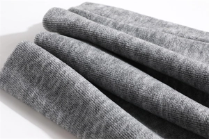 Close-up of grey corduroy neck warmer fabric showing soft velvet texture and ribbed patterns