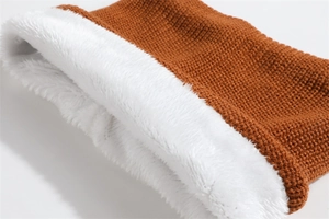 Detailed macro view of yellow knit texture and thick white fleece lining for winter warmth
