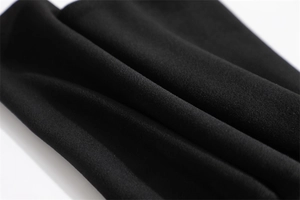 Macro shot of soft black thermal fabric texture with double-layer windproof stitching