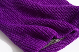 Detailed close-up of purple knitted scarf with warm grey faux fur lining texture