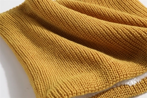 Detail of ginger knit neck warmer with soft white fleece lining for winter warmth