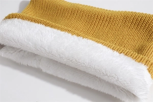 Detail of yellow knit scarf showing thick fleece lining and warm texture for winter