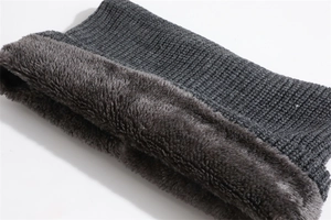 Detailed view of dark grey knitted scarf with thick fleece lining for cold protection