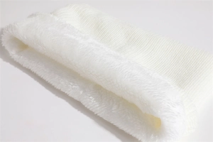 Close-up of white knitted winter hat showing thick warm fleece lining for cold protection