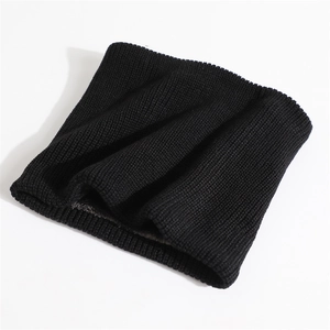 Detailed macro view of black ribbed knit texture on thermal neck warmer for winter