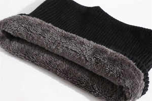 Detail of black chunky knit exterior and thick grey faux fur lining for thermal warmth