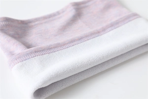 Detailed macro view of the purple knit fabric and thick white fleece lining on the neck warmer