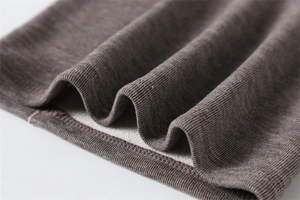 Close-up of knit winter neck warmer showing the thermal fleece lining and ribbed fabric
