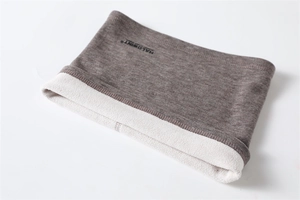 Detailed close-up of knitted winter neck warmer with soft fleece lining and brand logo