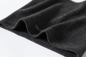 Detailed macro view of the soft fleece lining and knitted texture of the thermal neck gaiter