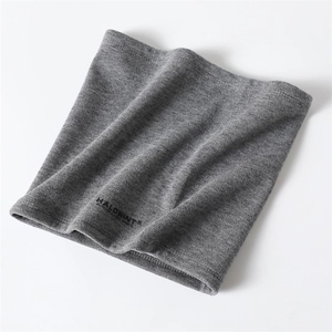 Detail shot of the gray knitted texture and black logo on the winter neck warmer