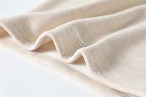 Detailed macro view of the cream-colored ribbed knit texture and soft fleece lining